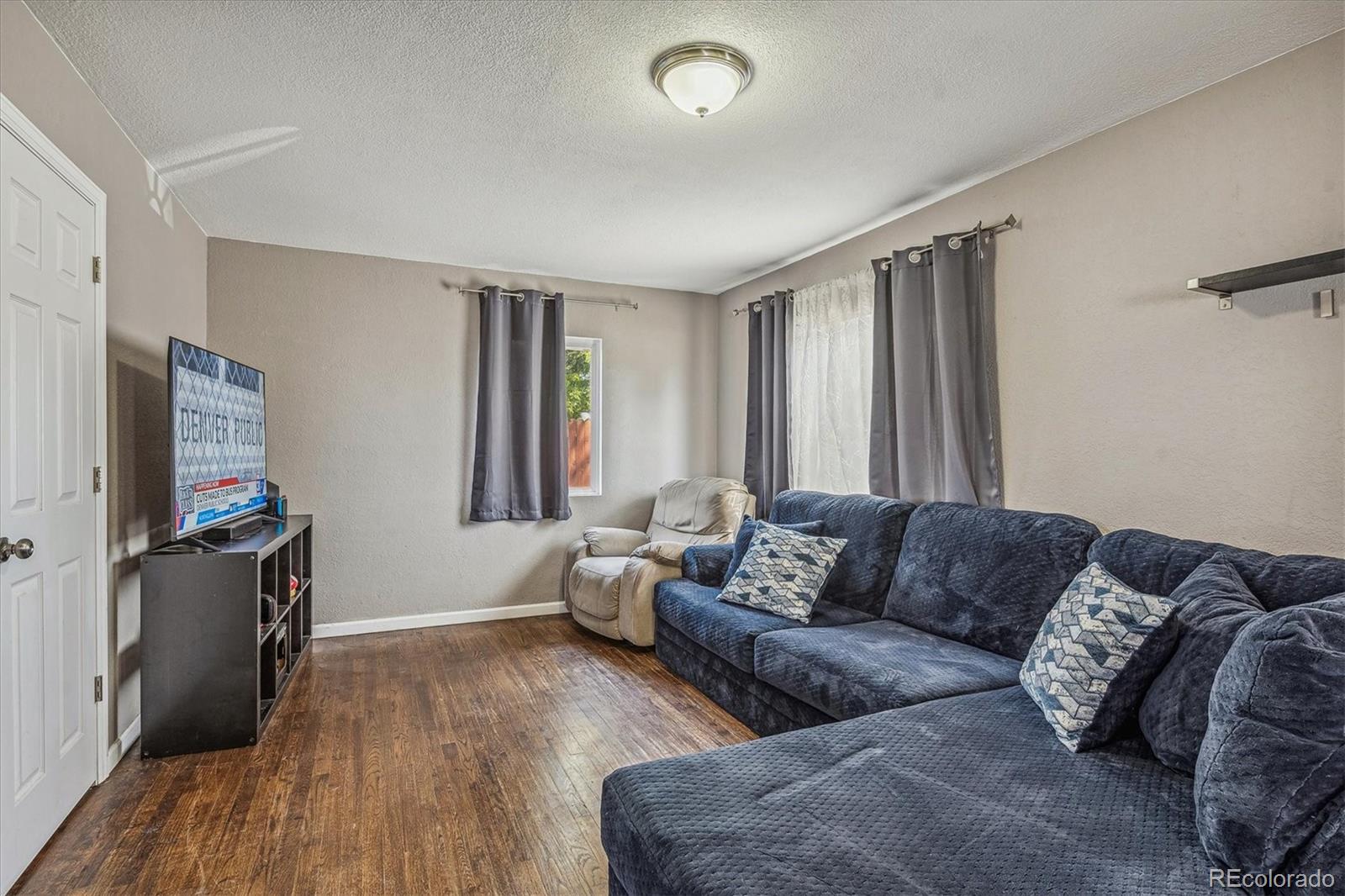 631 South Raleigh Street Denver, CO 80219 - Photo 3 of 15 a living room with furniture and a flat screen tv