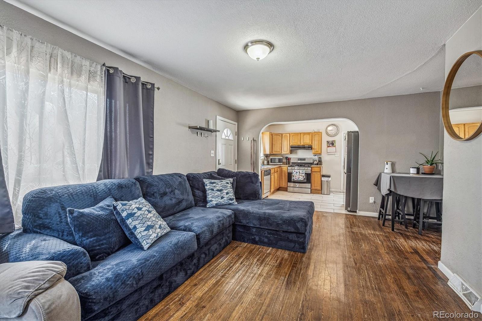 631 South Raleigh Street Denver, CO 80219 - Photo 5 of 15 a living room with furniture and a wooden floor