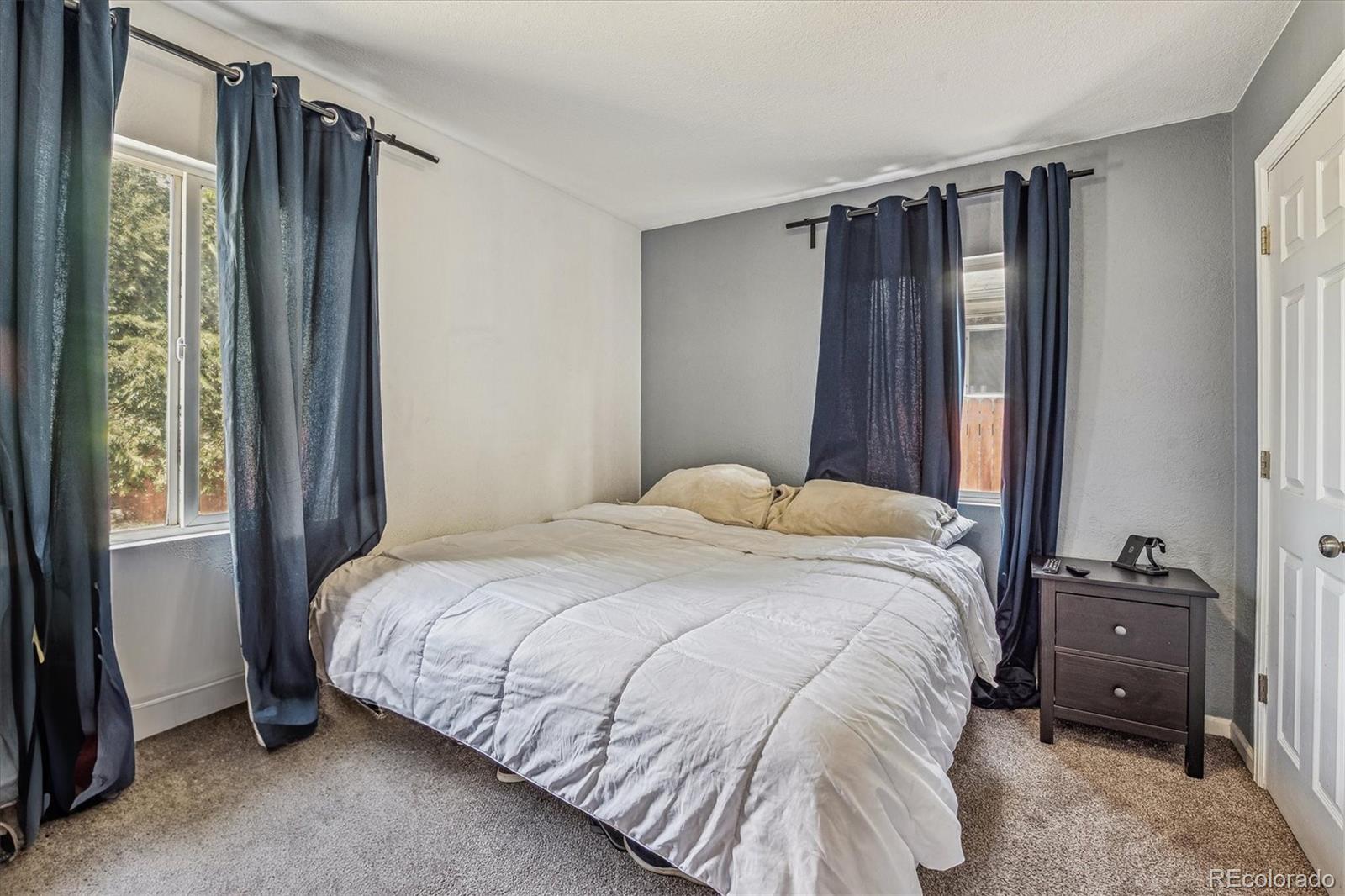 631 South Raleigh Street Denver, CO 80219 - Photo 9 of 15 a bedroom with a bed and a window