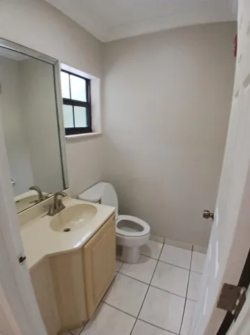 a bathroom with a sink toilet and window