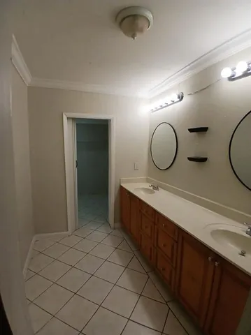 a bathroom with a double vanity sink mirror and vanity