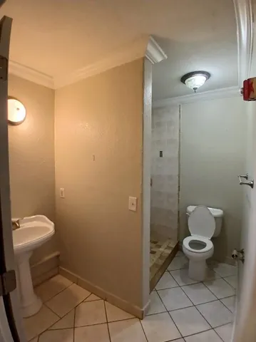 a bathroom with a toilet and a shower