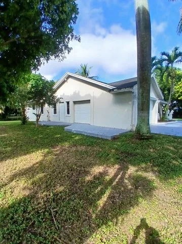 a front view of house with garden