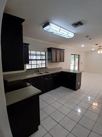 a kitchen with a sink and cabinets
