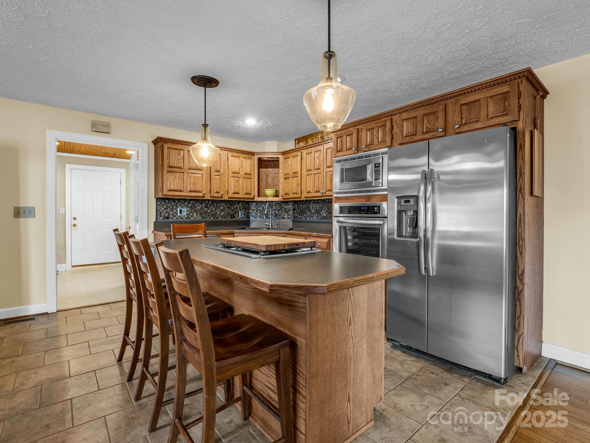 505 Crawley Gin Road Shelby, NC 28150 - Photo 6 of 48 a kitchen with a table and refrigerator