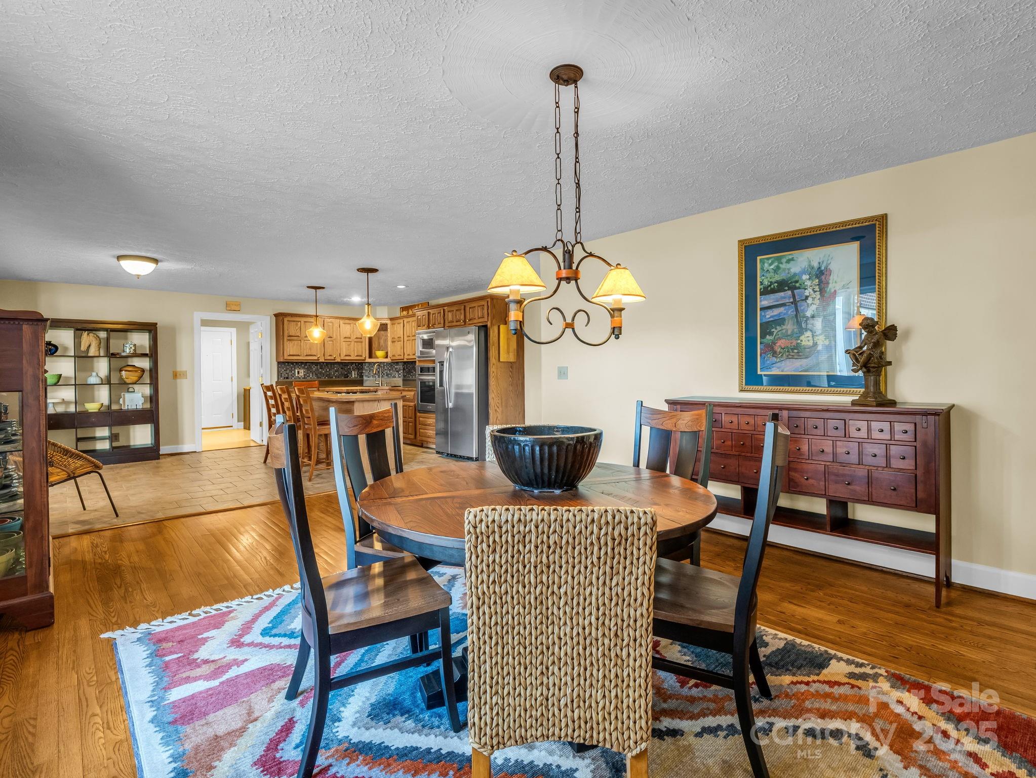 505 Crawley Gin Road Shelby, NC 28150 - Photo 8 of 48 a view of a dining room and livingroom with furniture wooden floor a rug a painting and a chandelier