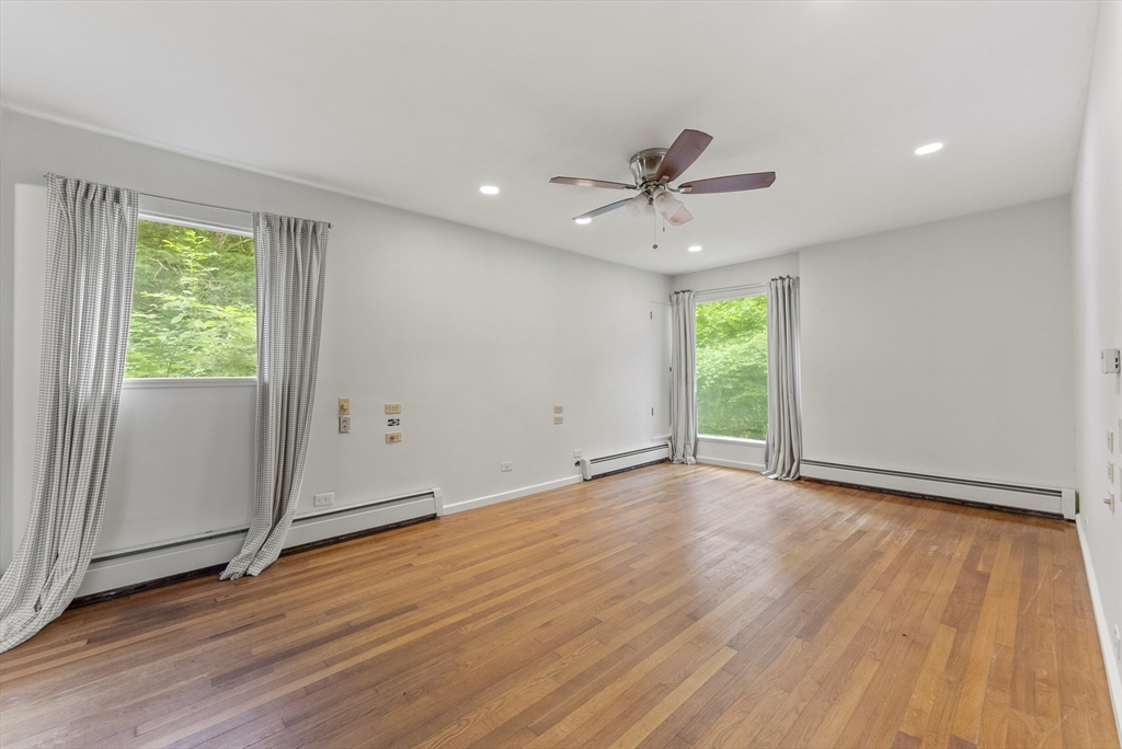 505 Mountain Road Wilbraham, MA 01095 - Photo 16 of 35 an empty room with wooden floor fan and windows