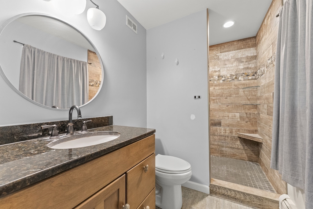 505 Mountain Road Wilbraham, MA 01095 - Photo 19 of 35 a bathroom with a granite countertop sink a toilet and a mirror