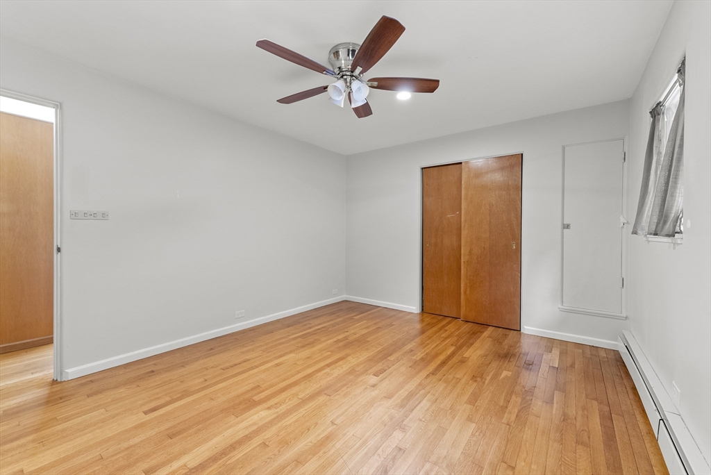 505 Mountain Road Wilbraham, MA 01095 - Photo 27 of 35 an empty room with wooden floor and a ceiling fan