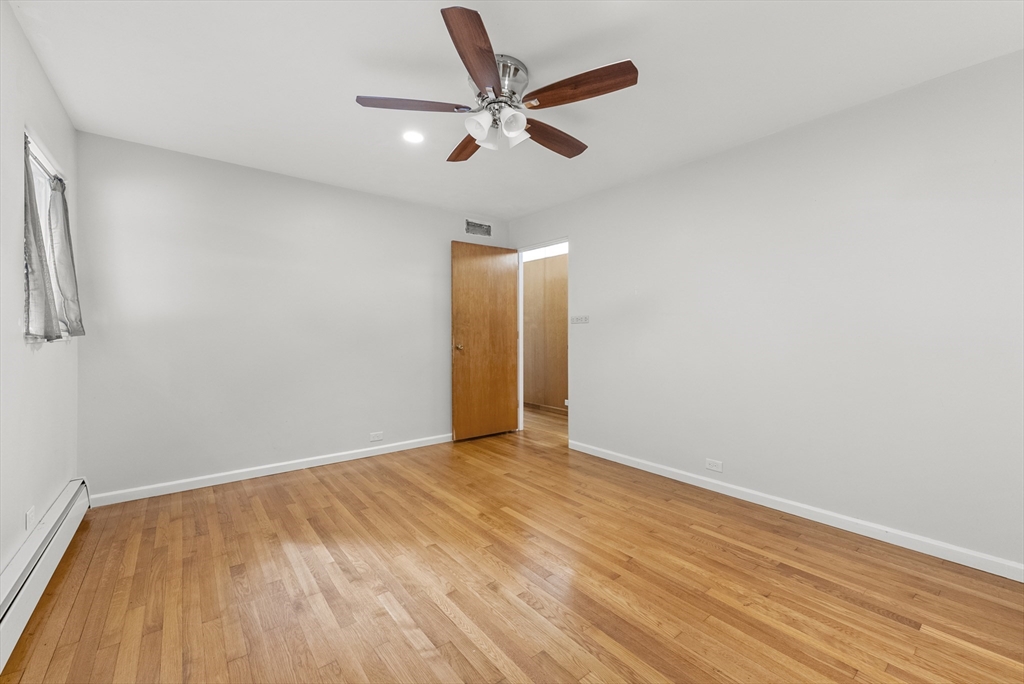 505 Mountain Road Wilbraham, MA 01095 - Photo 28 of 35 an empty room with wooden floor and a ceiling fan