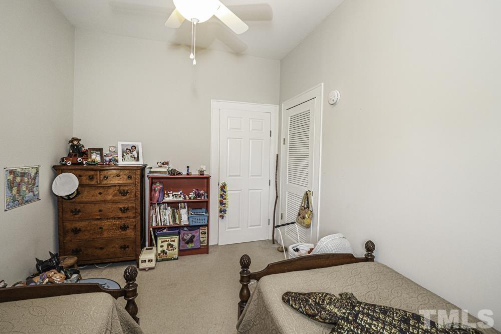 3188 Macedonia Road Spring Hope, NC 27882 - Photo 42 of 84 a bedroom with a bed and a chandelier