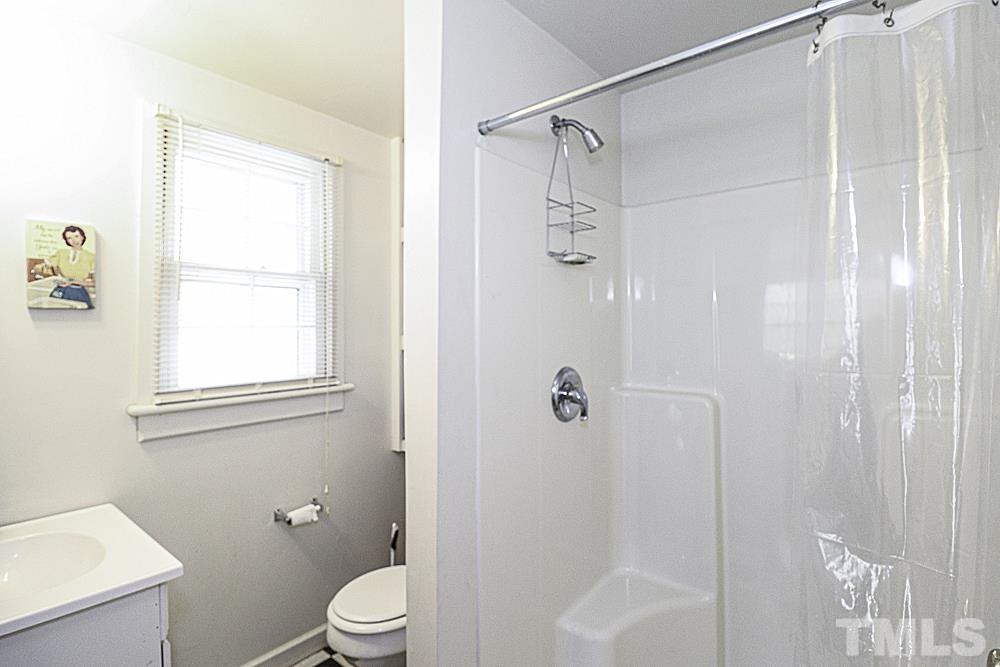 3188 Macedonia Road Spring Hope, NC 27882 - Photo 64 of 84 a bathroom with a shower a toilet and a window