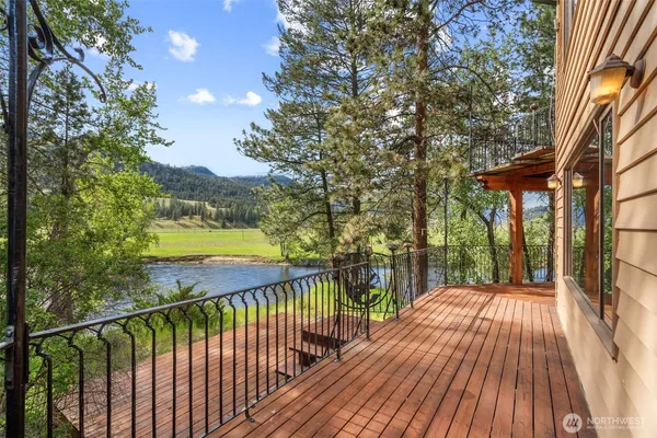 a view of balcony with wooden floor and fence