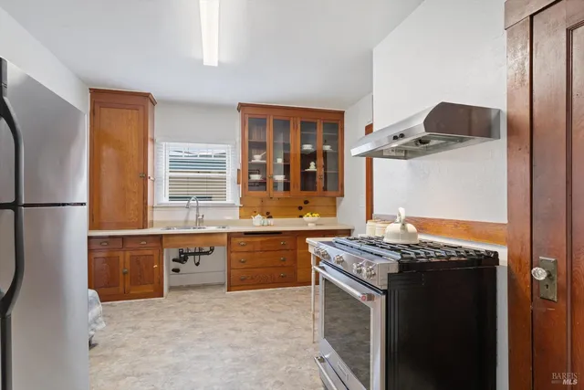 a front view of a house with a garden and plants