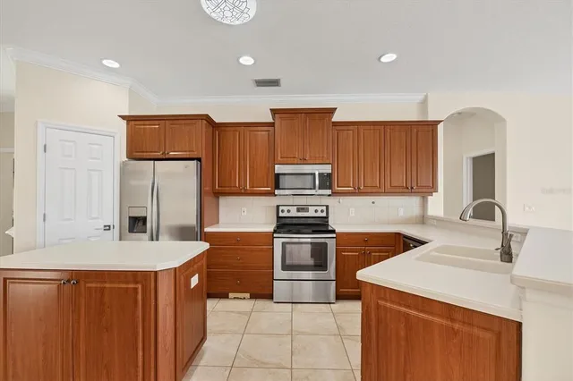 a kitchen with stainless steel appliances a refrigerator stove and sink