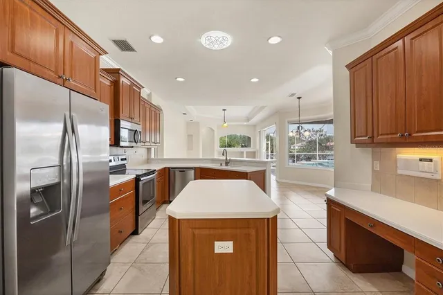 a kitchen with stainless steel appliances granite countertop a refrigerator a oven a sink a stove and a cabinets