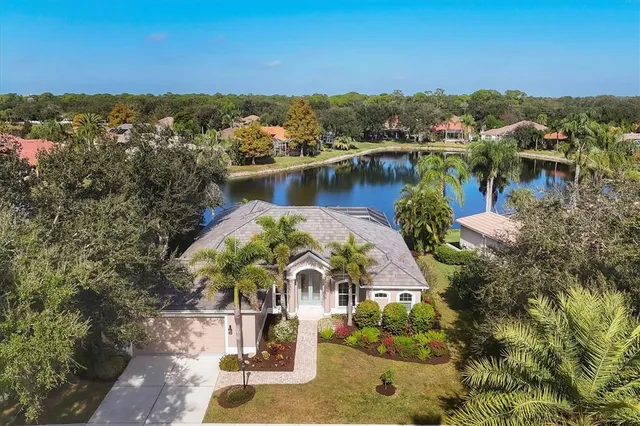 a view of a lake with a house in a yard