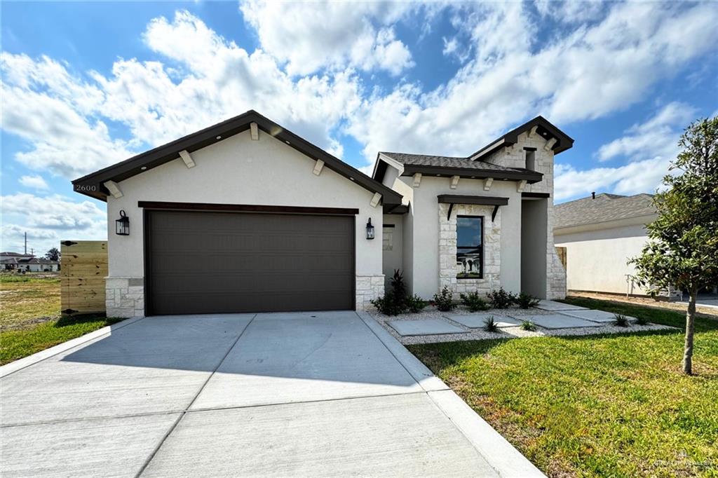 2600 East Conroe Road Edinburg, TX 78542 - Photo 1 of 1 View of front of house with a front lawn and a garage