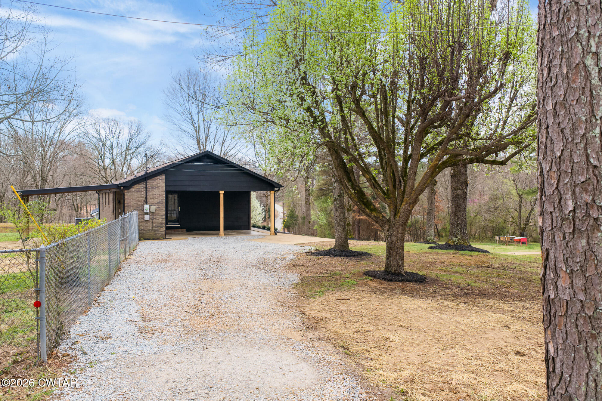 605 Parkburg Road Pinson, TN 38366 - Photo 4 of 15 a front view of a house with a yard and garage