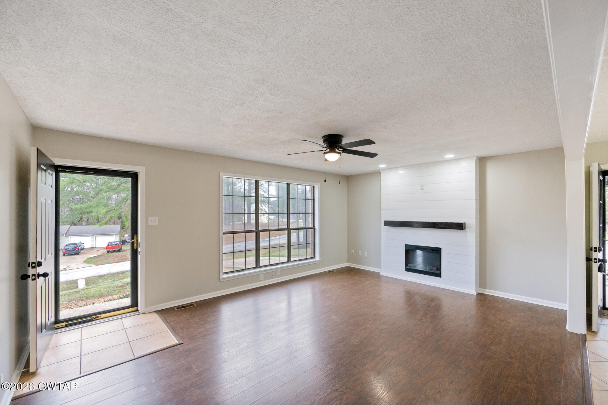 605 Parkburg Road Pinson, TN 38366 - Photo 6 of 15 an empty room with windows fireplace and a sink