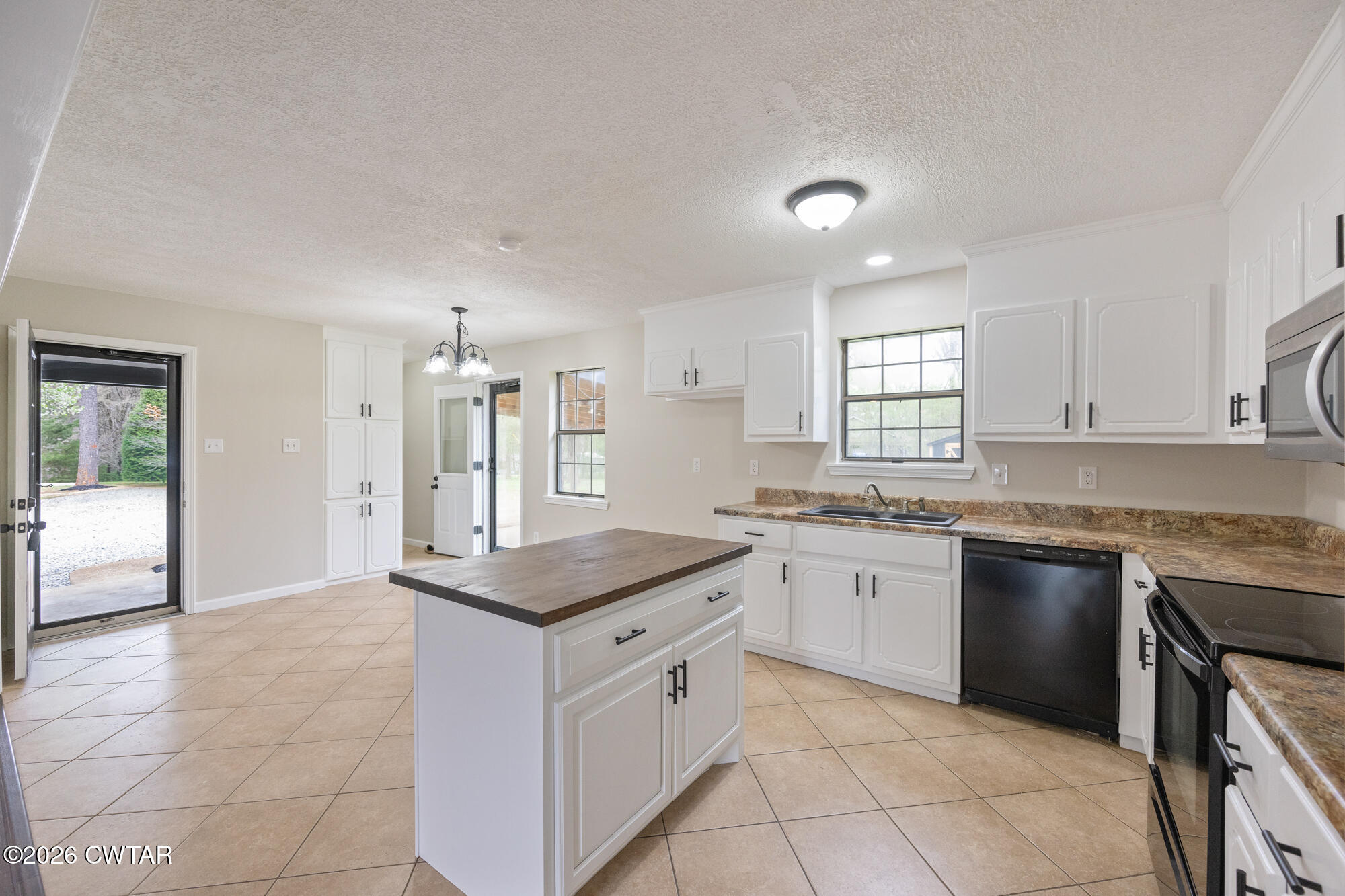 605 Parkburg Road Pinson, TN 38366 - Photo 8 of 15 a kitchen with granite countertop a sink stove and cabinets