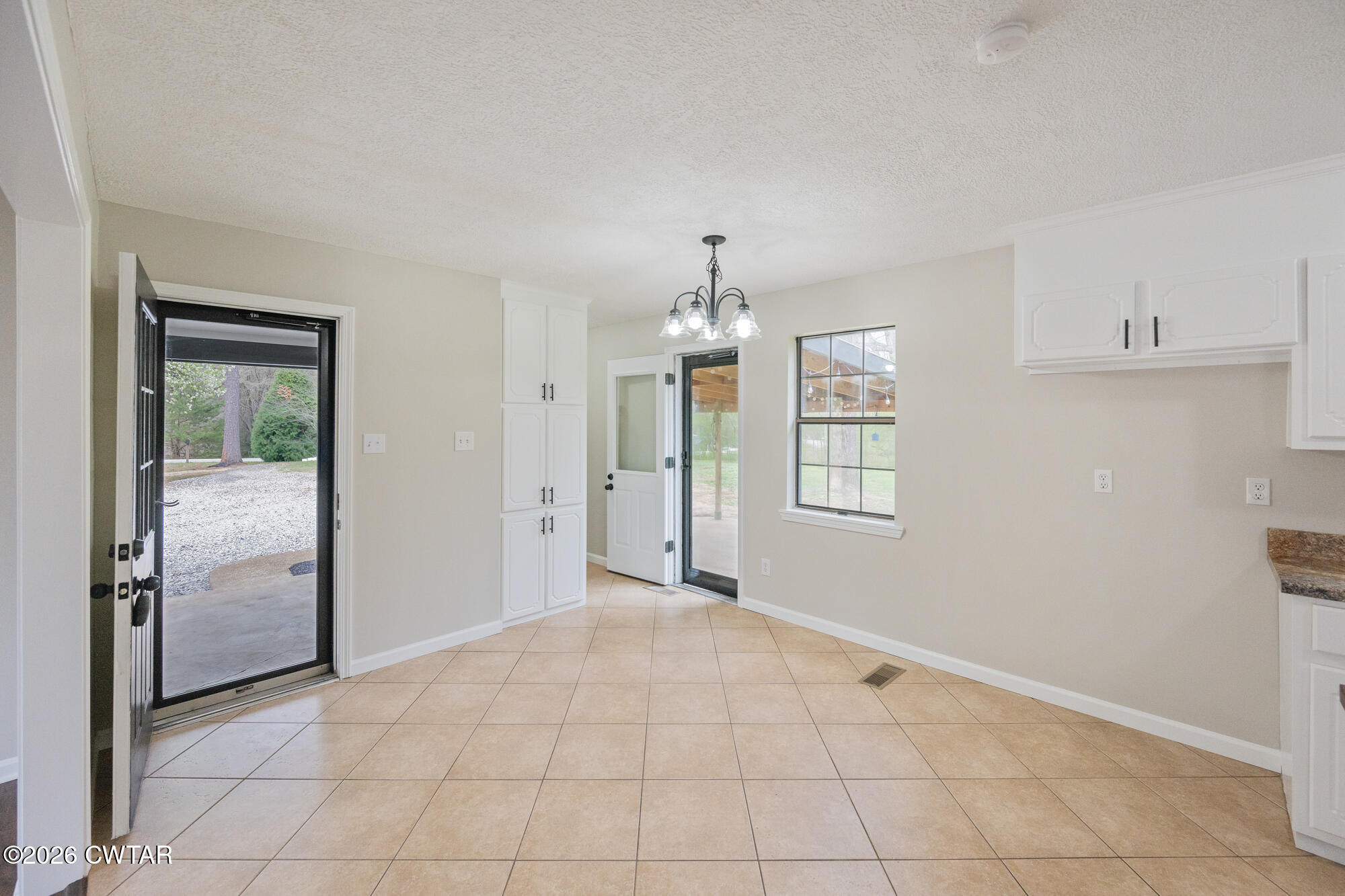 605 Parkburg Road Pinson, TN 38366 - Photo 9 of 15 an empty room with chandelier fan and windows