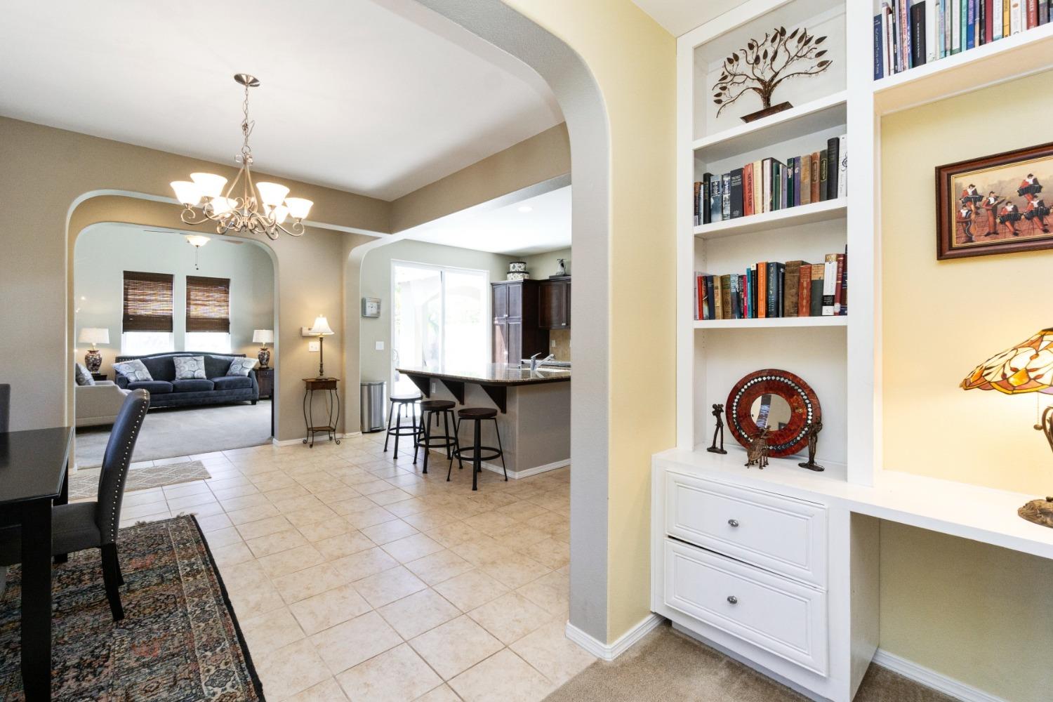 4103 Harlan Ranch Boulevard Clovis, CA 93619 - Photo 12 of 31 a view of a dining room with furniture and a chandelier