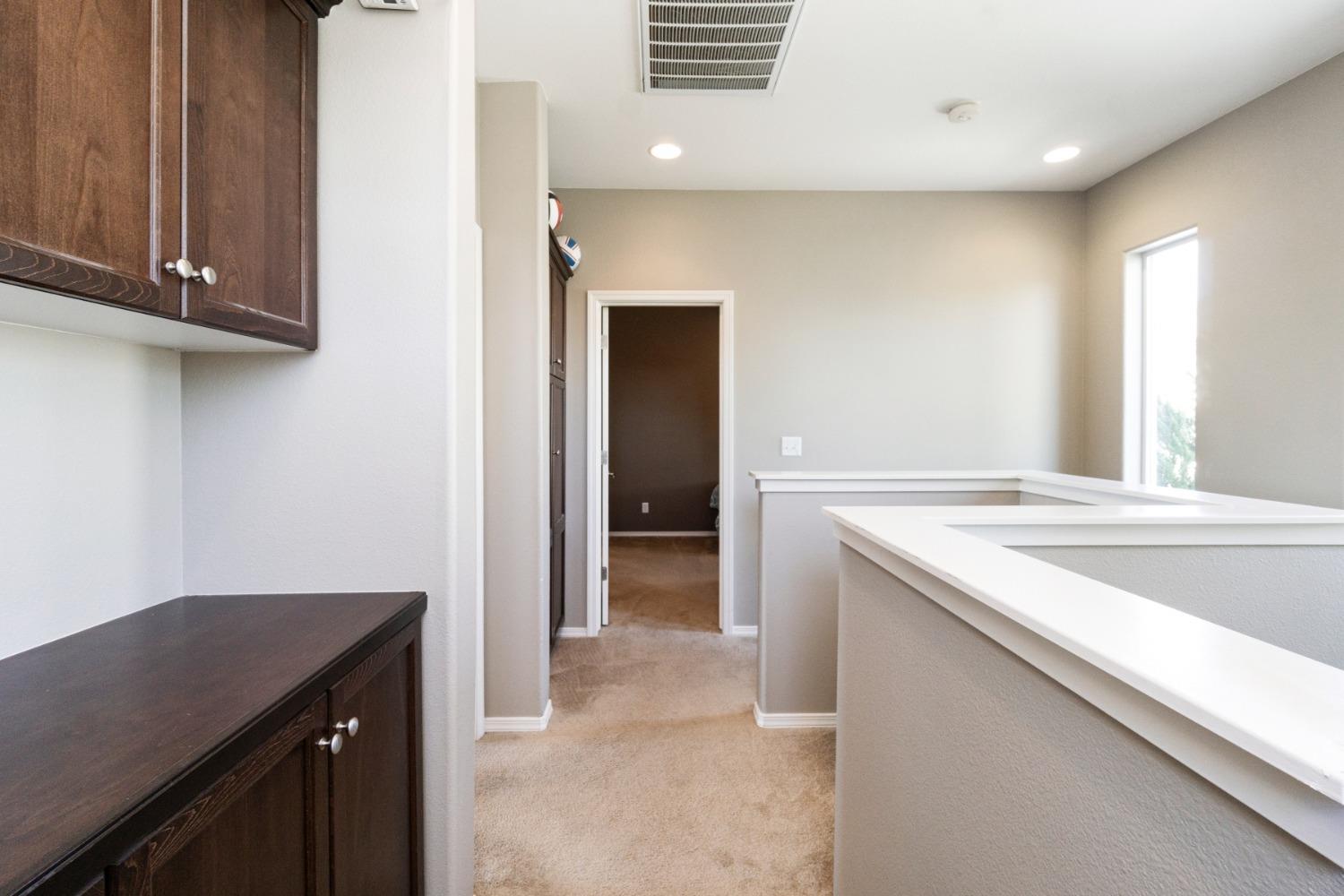 4103 Harlan Ranch Boulevard Clovis, CA 93619 - Photo 15 of 31 a kitchen with a sink and cabinets