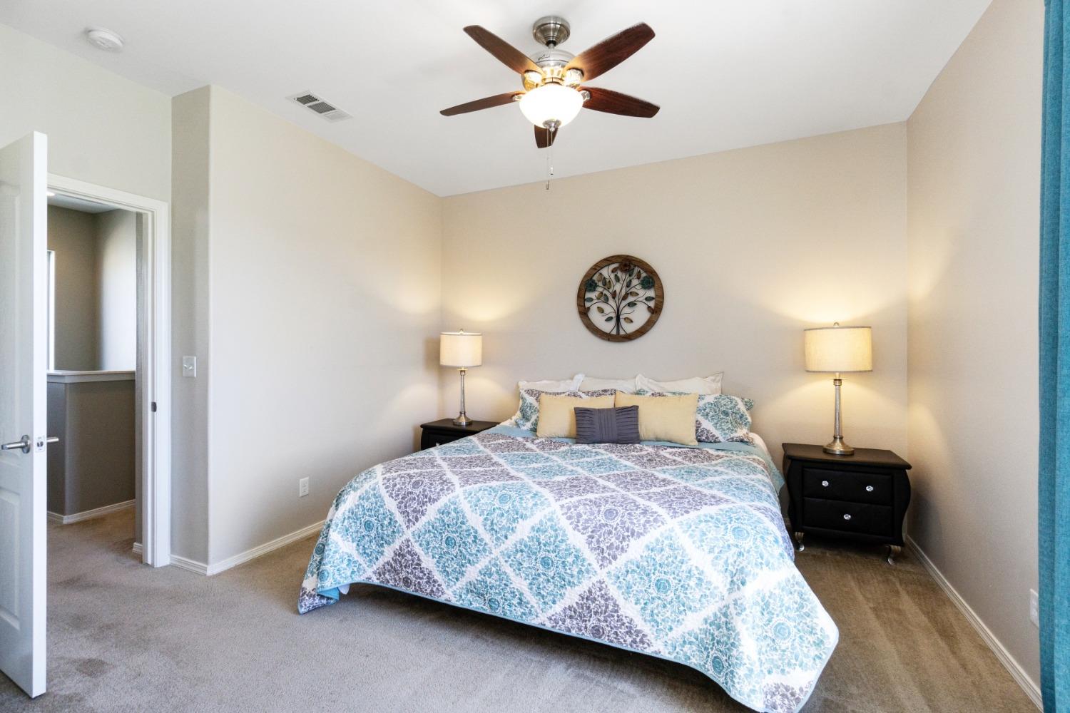 4103 Harlan Ranch Boulevard Clovis, CA 93619 - Photo 20 of 31 a bedroom with a bed and a chandelier