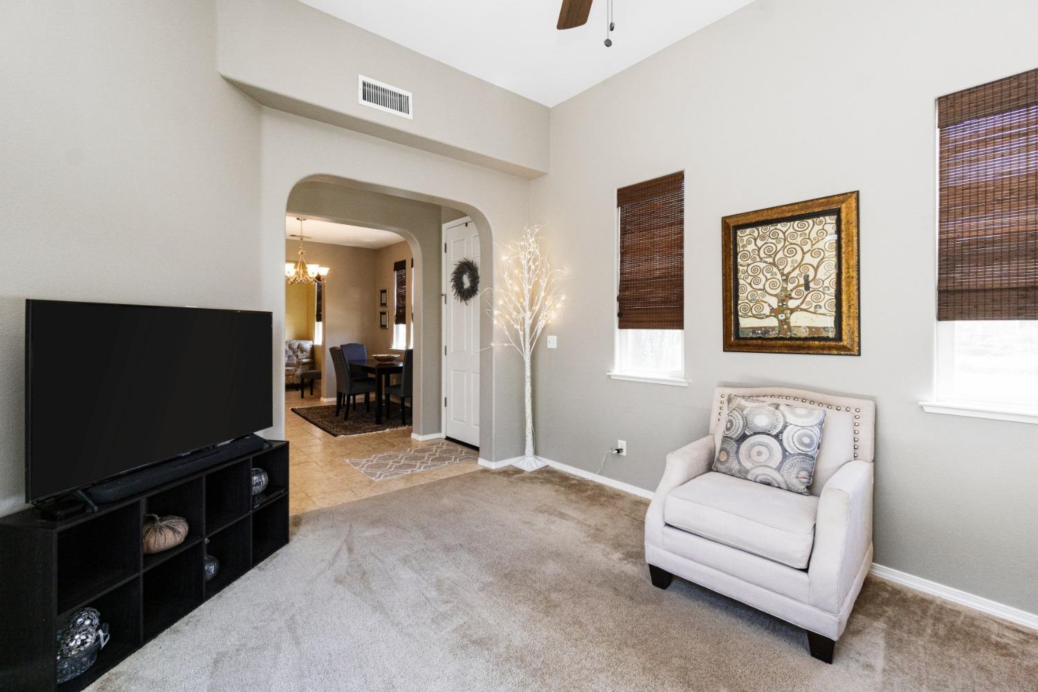 4103 Harlan Ranch Boulevard Clovis, CA 93619 - Photo 6 of 31 a living room with furniture and a flat screen tv