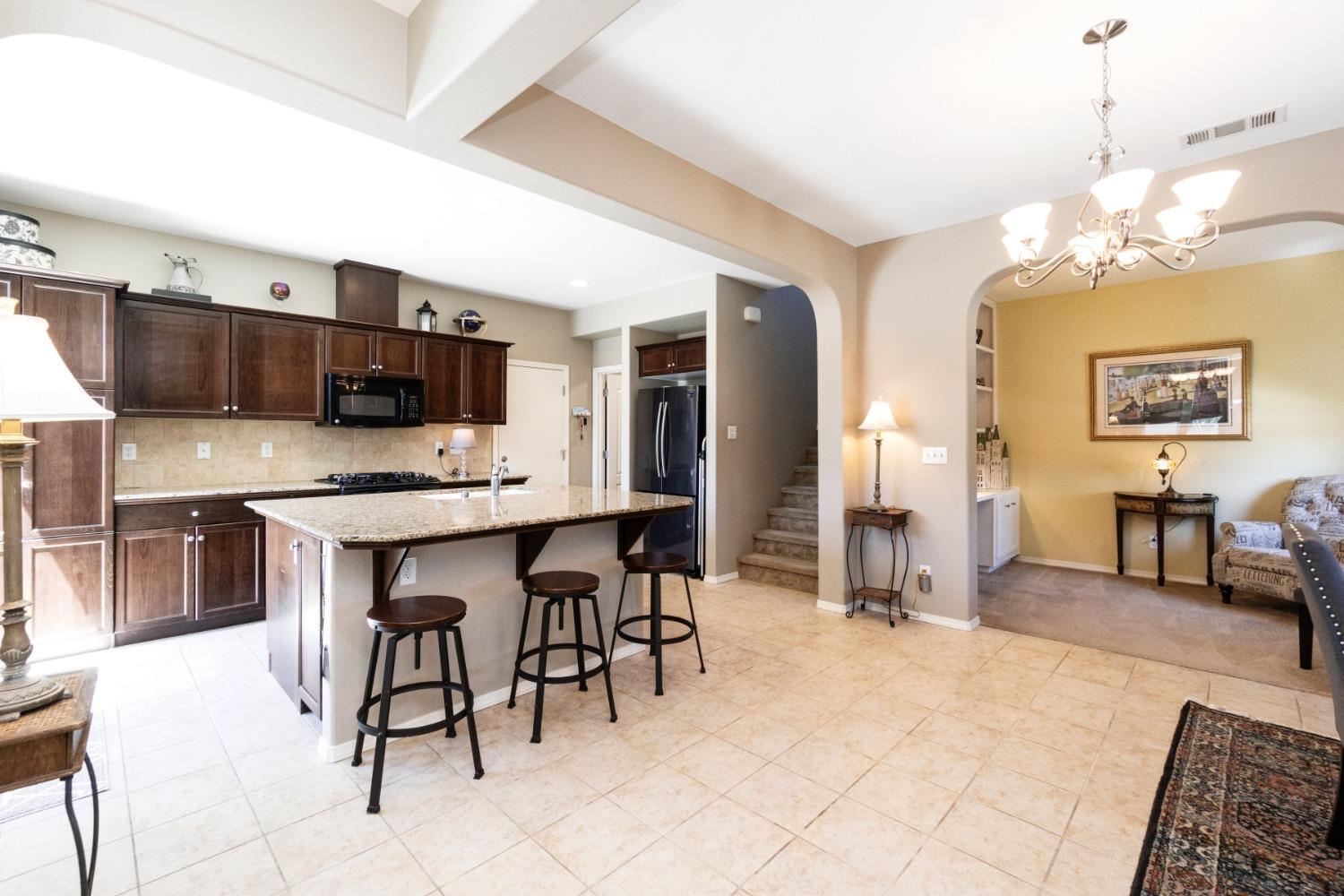 4103 Harlan Ranch Boulevard Clovis, CA 93619 - Photo 7 of 31 a large kitchen with a table and chairs