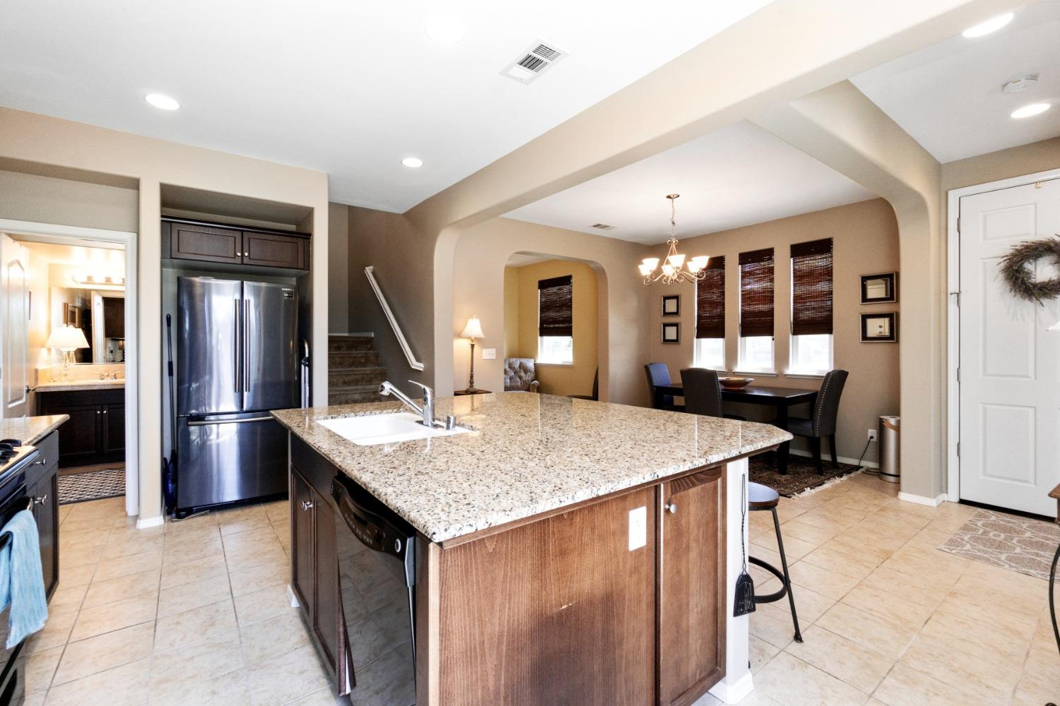 4103 Harlan Ranch Boulevard Clovis, CA 93619 - Photo 10 of 31 a kitchen with a counter top space and stainless steel appliances