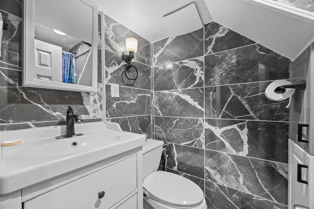 a bathroom with a sink toilet and shower