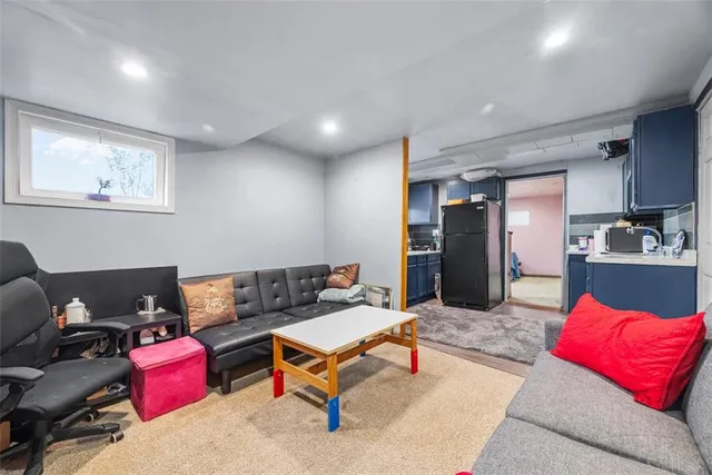 a living room with furniture and kitchen view