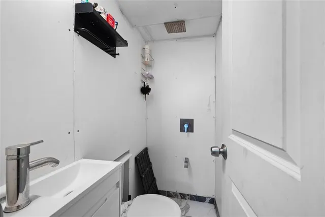 a bathroom with a sink toilet and vanity