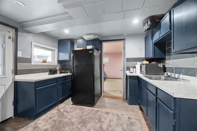 a kitchen with refrigerator cabinets and furniture
