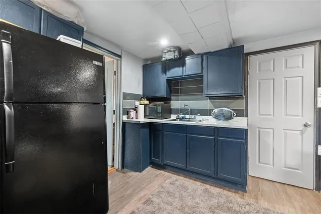 a kitchen with a refrigerator and a sink