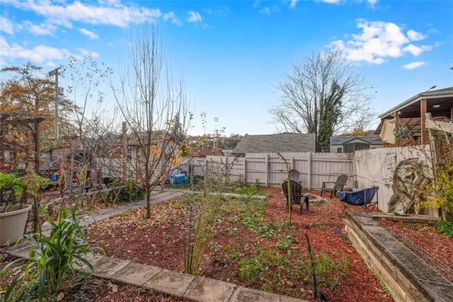 a backyard of a house with table and chairs