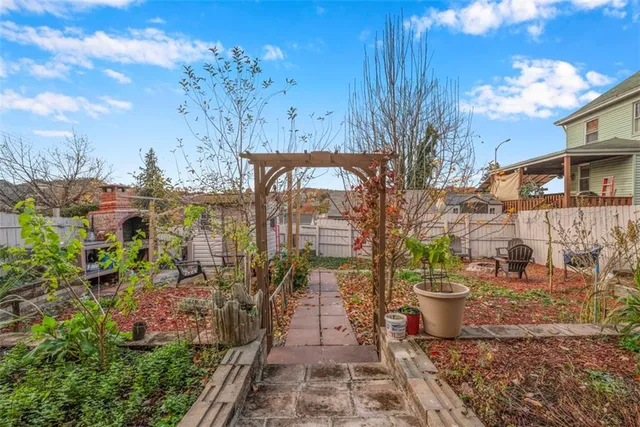 a view of house with backyard and outdoor seating