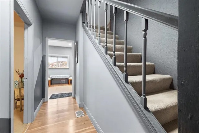 a view of entryway and hall with wooden floor