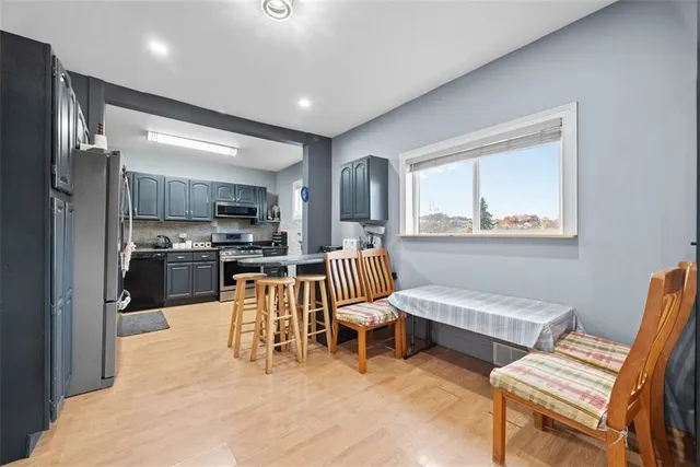 a living room with furniture and kitchen view
