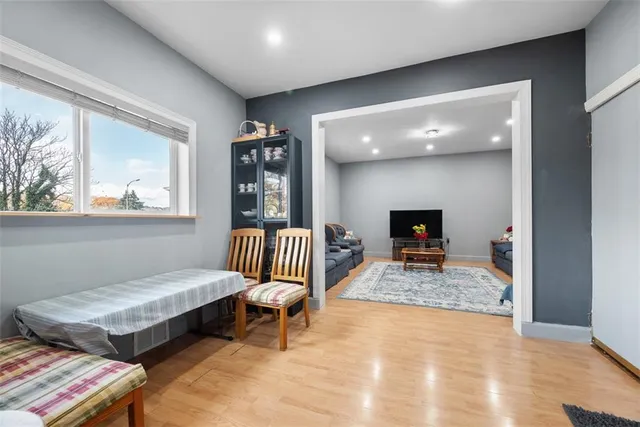 a bedroom with furniture and a wooden floor