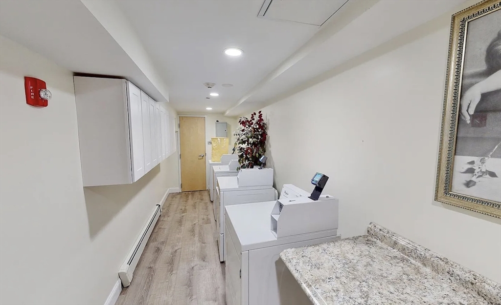 9 Anderson Street, Unit 1R Boston, MA 02114 - Photo 11 of 13 a living room with furniture and a couch