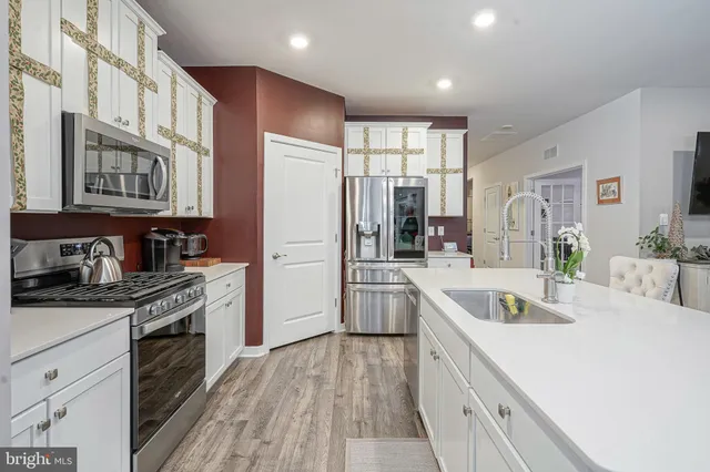a kitchen with stainless steel appliances granite countertop a refrigerator sink and cabinets