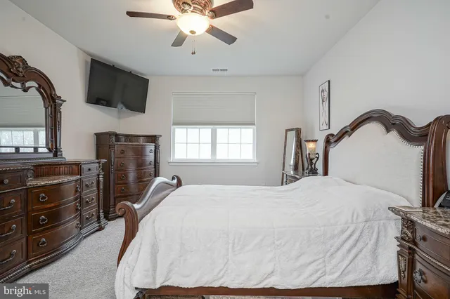 a view of walk in closet with clothes