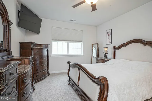 a bedroom with furniture and a window