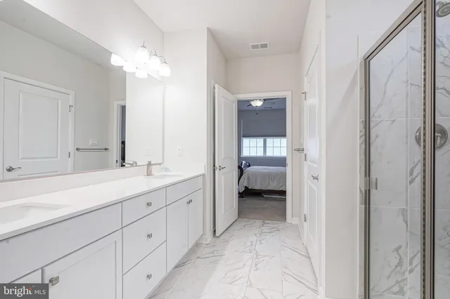 a view of a hallway with workspace and wooden floor