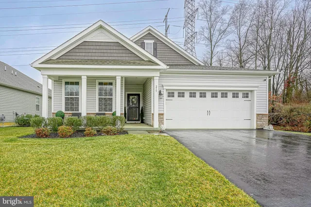 a front view of a building with a yard