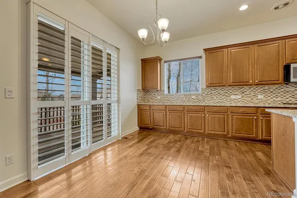 a kitchen with granite countertop a stove a sink and a microwave oven