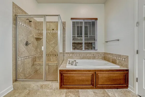 a bathroom with a tub and a shower
